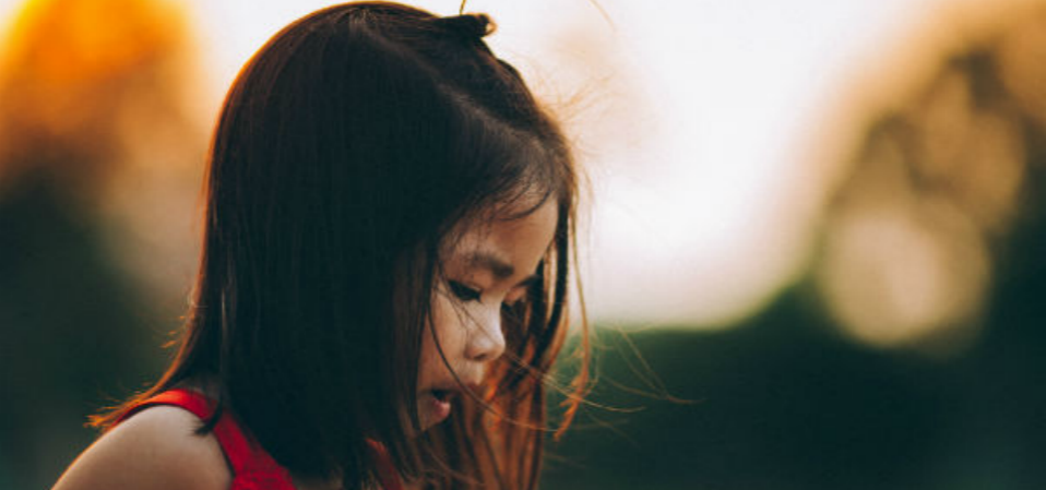 A young girl playing outside