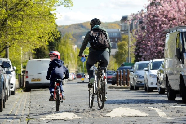 Photo of cyclists cycling over a road ramp