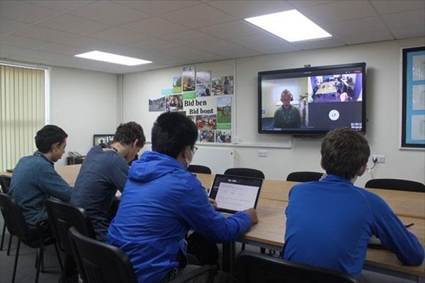 Students join class at another school via video link.
