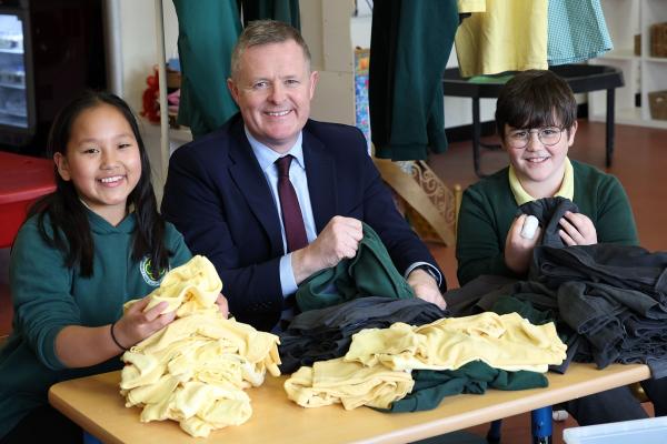 Education minister with school uniforms.