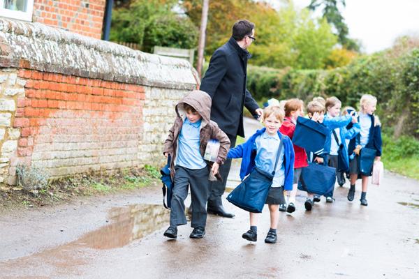 Pupils walking outside with a teacher
