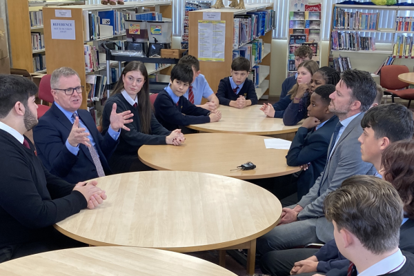 Jeremy Miles, the Minister for Education and Welsh language speaking with school learners.
