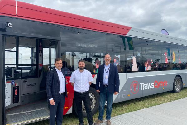 Cabinet Secretary Ken Skates, Adam Marshall, head of commercial at Arriva Cymru, and Lee Robinson, TfW, in front of a TrawsCymru bus.