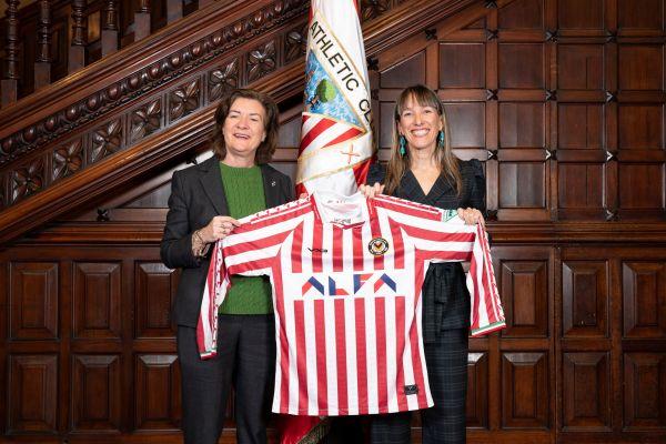 Eluned Morgan, has presented a commemorative Newport County football shirt to the Bilbao team Athletic Club.