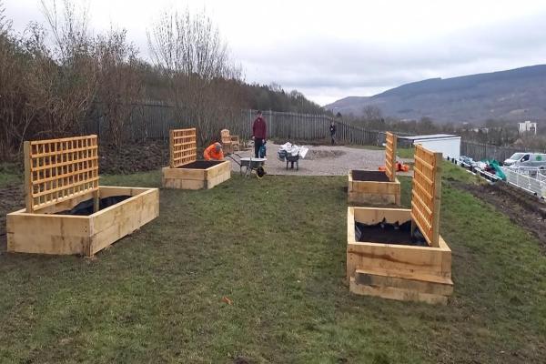 Newly installed raised beds and trellises at Merthyr Town FC’s remembrance and wildlife garden.
